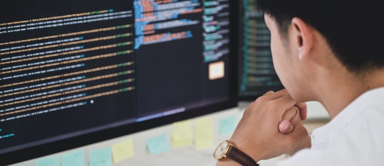 PHP udvikling - Udvikler sidder foran skærm med PHP kode